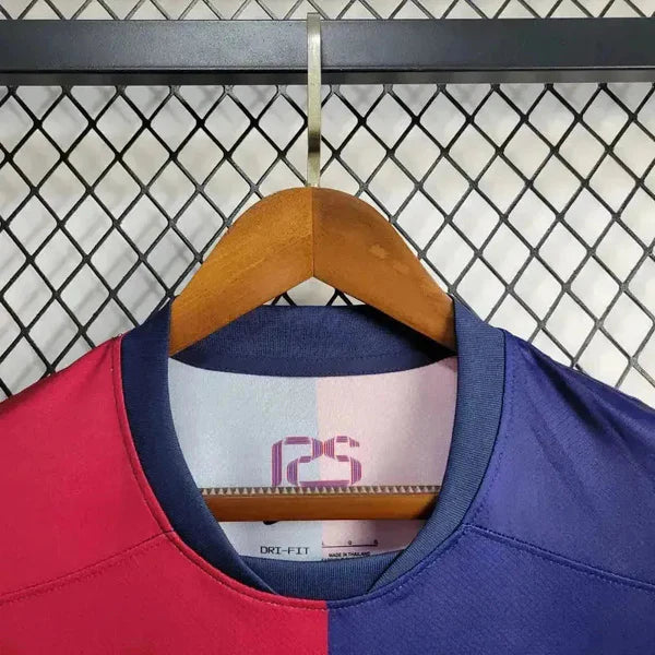 rn-image_picker_lib_temp_c3f67b26-f7da-4069-a59e-54f119d47338 | UAE SPORT STORE Two-tone pink and blue color-block sports jersey on a wooden hanger, with a navy collar.