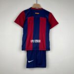 Back view of a blue and maroon striped sports jersey on a wooden hanger, featuring a UNHCR logo near the lower back.
