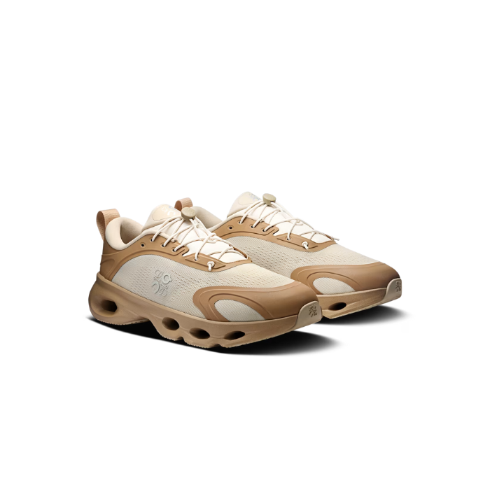 rn-image_picker_lib_temp_c841a608-1549-439f-a665-1b225983eb1b | UAE SPORT STORE Beige and tan chunky athletic sneakers with thick sole, shown from a three-quarter front view.
