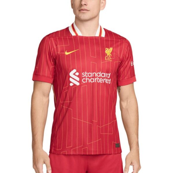 Liverpool FC home jersey in red with gold crest and white 'Standard Chartered' sponsor logo on the chest.