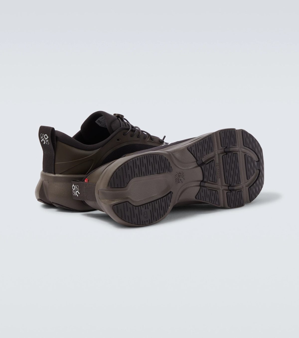 Close-up of a brown hiking shoe with a rugged sole, cropped at the bottom edge in a studio shot