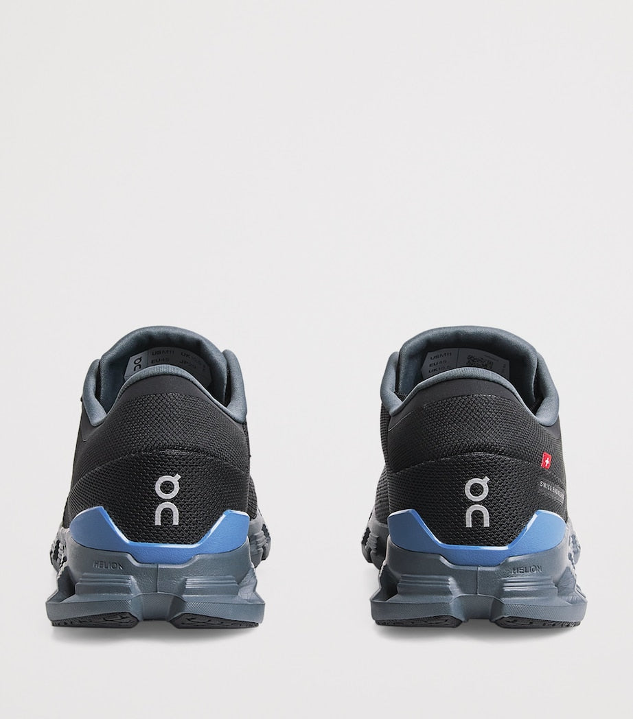 rn-image_picker_lib_temp_d5087a72-6aa5-4631-913f-b8fa9c491fe6 | UAE SPORT STORE Back view of a pair of black running shoes with blue heel accents and the white On logo visible on the heels.