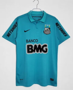 Turquoise Santos FC soccer jersey on a hanger with Banco BMG sponsor, Nike swoosh, crest, and NETSHOES on sleeves.