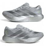 rn-image_picker_lib_temp_d9471125-58b3-47a6-85d4-d12ccd72c17a | UAE SPORT STORE Two silver-gray running shoes shown from side and profile views with thick platform soles and three diagonal stripes on each side.