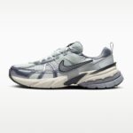 Close-up side view of a gray athletic running shoe with mesh upper, layered panels, and a chunky sole.