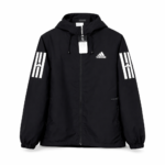 rn-image_picker_lib_temp_d98af632-4ee0-4fff-85ba-f37b57b5c3d9 | UAE SPORT STORE Black Adidas windbreaker with hood and front zipper, white Adidas logo on the left chest and bold white stripes on each sleeve.