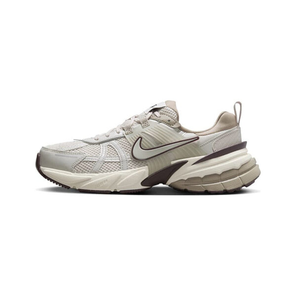 Beige and white Nike running shoe shown in side profile with a black outline swoosh logo.