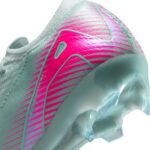 Close-up of a modern running shoe heel with pink and teal diagonal stripe design and translucent sole edge