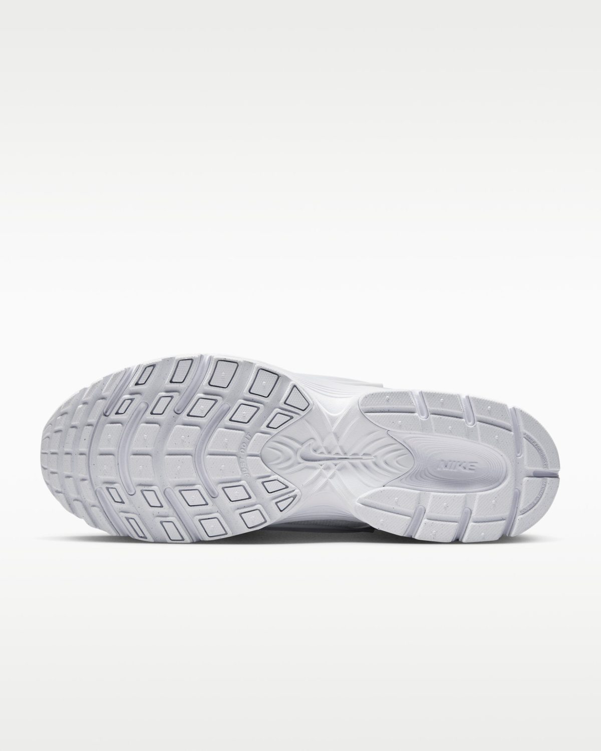 Bottom view of a white Nike running shoe sole showing a multi-angled tread pattern on the outsole.
