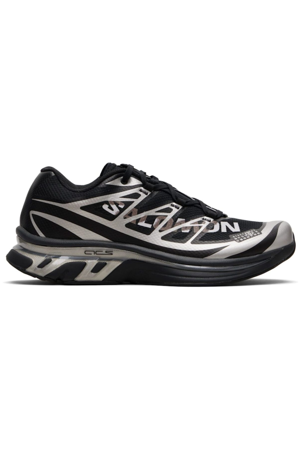 Side view of a black-and-white running shoe with geometric overlays and a thick cushioned sole