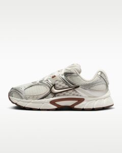 rn-image_picker_lib_temp_e6cb2a96-dc46-4470-b808-b9982c2c12ae | UAE SPORT STORE White and gray athletic sneaker with a brown Nike swoosh, shown from the side with a chunky sole and breathable mesh panels.