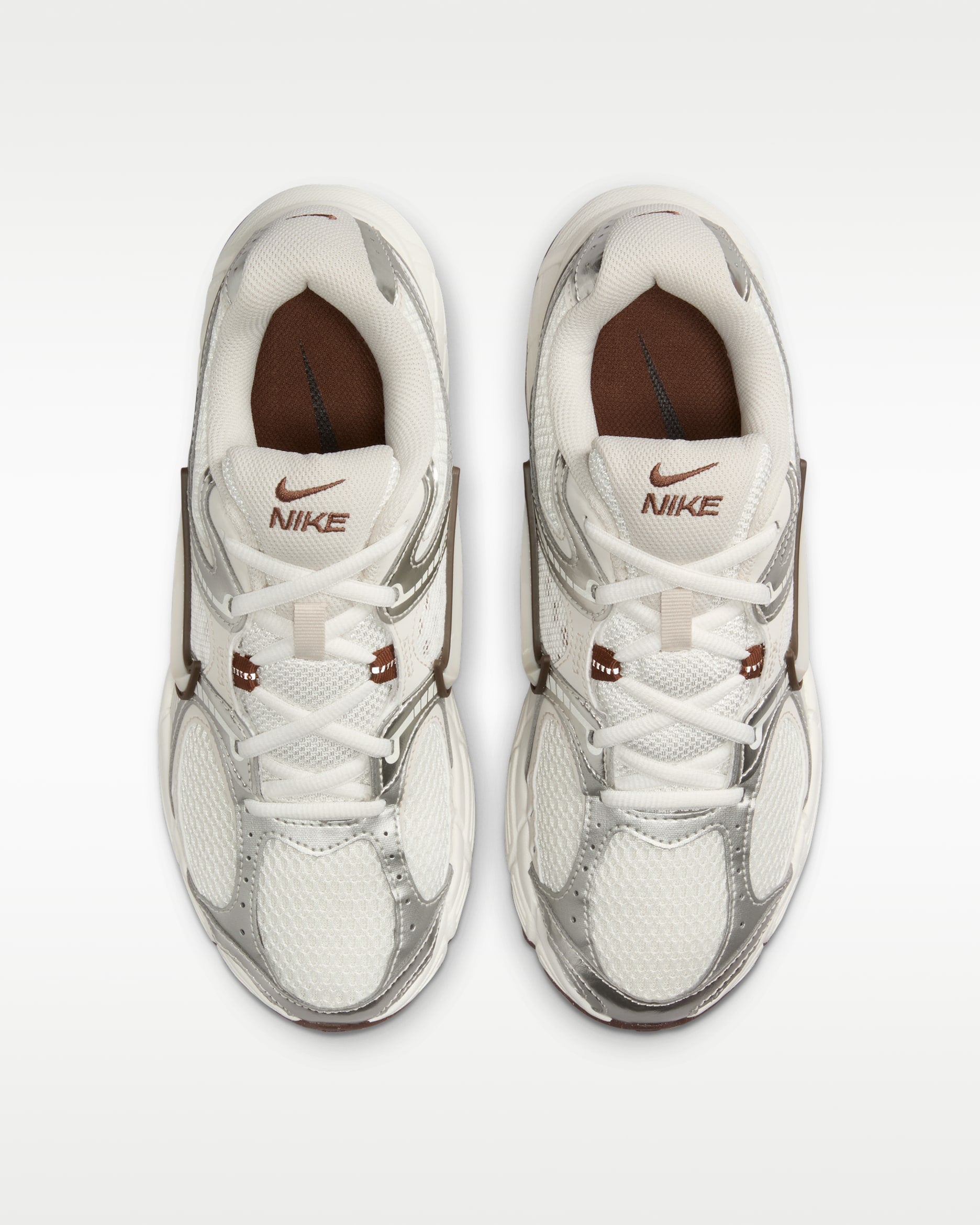 rn-image_picker_lib_temp_e7d12bdf-ea7d-4efe-a1fb-f061dd522e4a | UAE SPORT STORE Top-down view of two white Nike sneakers placed side by side on a white background.