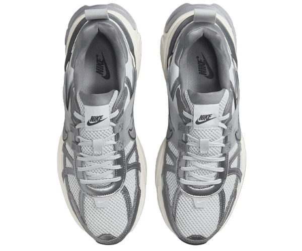 Top-down view of a pair of gray and white Nike running shoes side by side.