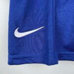 Close-up of blue fabric with a white Nike swoosh logo embroidery