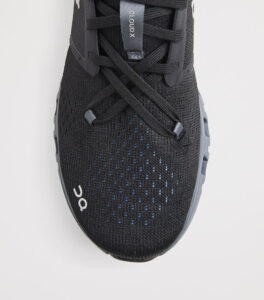 rn-image_picker_lib_temp_f3270319-1ed4-4ce1-b239-4c02758762c4 | UAE SPORT STORE Top view of a black On Cloud X running shoe, showing knit upper, laces, and branding on the tongue.