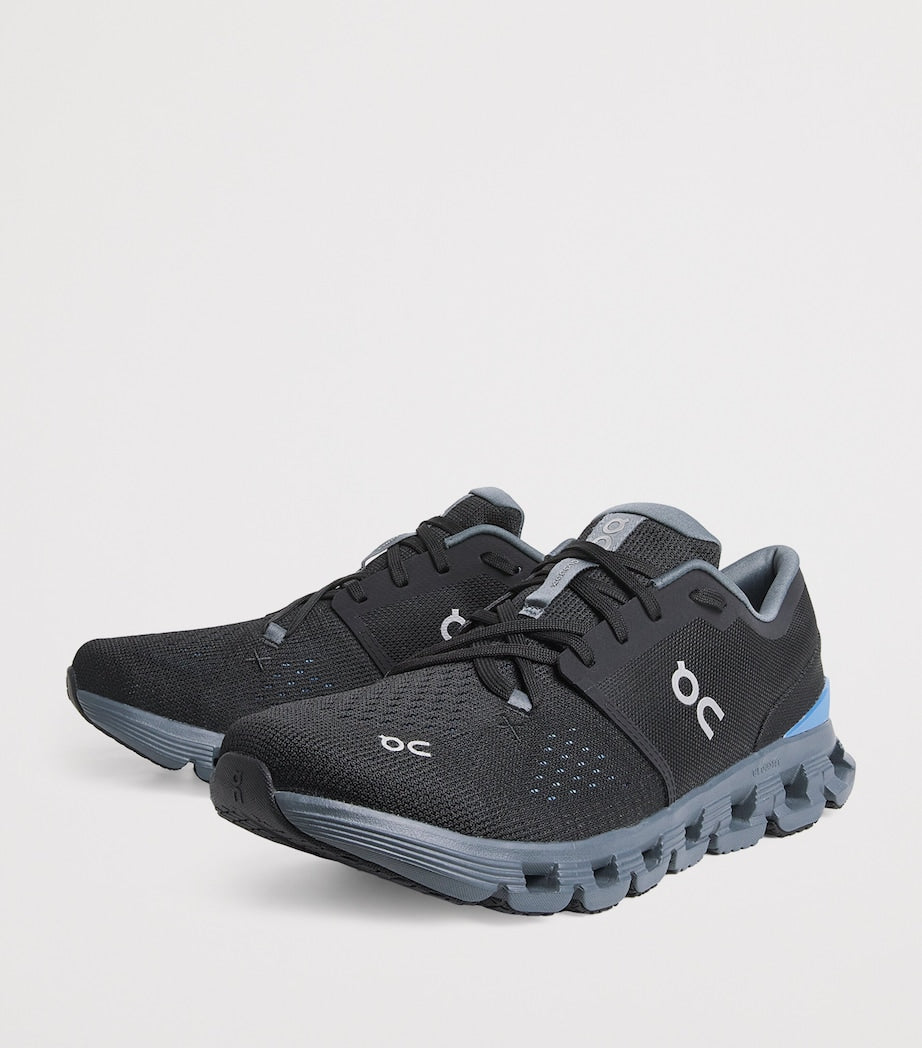 rn-image_picker_lib_temp_f6f7795f-0f00-4f17-b9a5-367b81ad9b9f | UAE SPORT STORE Black ON-brand running sneakers with breathable mesh upper, gray midsole, and blue heel detail photographed from a side angle.