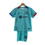 Turquoise FC Barcelona soccer jersey on a wooden hanger, with Nike logo and Spotify sponsor visible on the front.