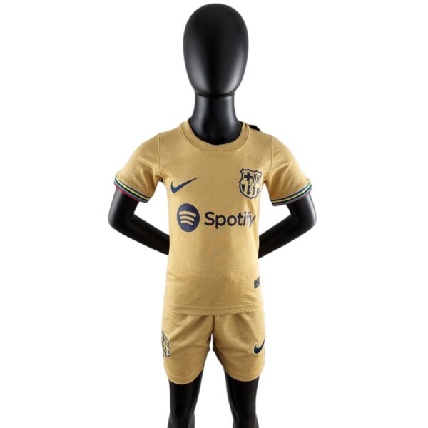 Front view of a black mannequin wearing a gold FC Barcelona jersey with the club crest and Spotify logo visible.