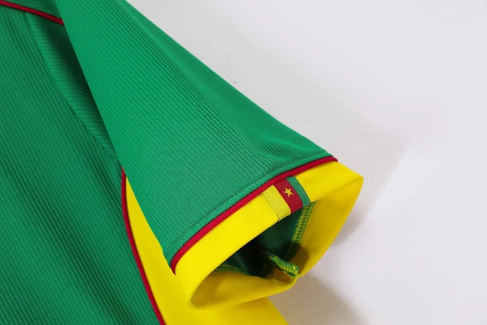 rn-image_picker_lib_temp_fe5bffcf-5f74-44b8-a646-89beb0729194 | UAE SPORT STORE Close-up of a green sports jersey sleeve with a yellow cuff and red trim, featuring a small flag emblem with a star