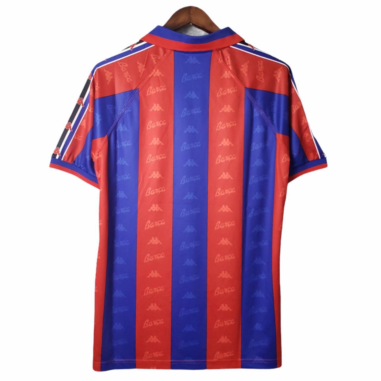 rn-image_picker_lib_temp_ff68a336-4633-4442-8f9d-d71c93152d96 | UAE SPORT STORE Back view of a red and blue vertical striped soccer jersey with repeating Kappa logos on the stripes.