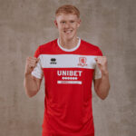 Young male soccer player facing camera, wearing a red and white jersey with the UNIBET sponsor logo and team crest.