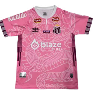 Pink soccer jersey with a white dragon motif and sponsor logos across the chest, including blaze.com and Umbro, with the team crest on the left chest.