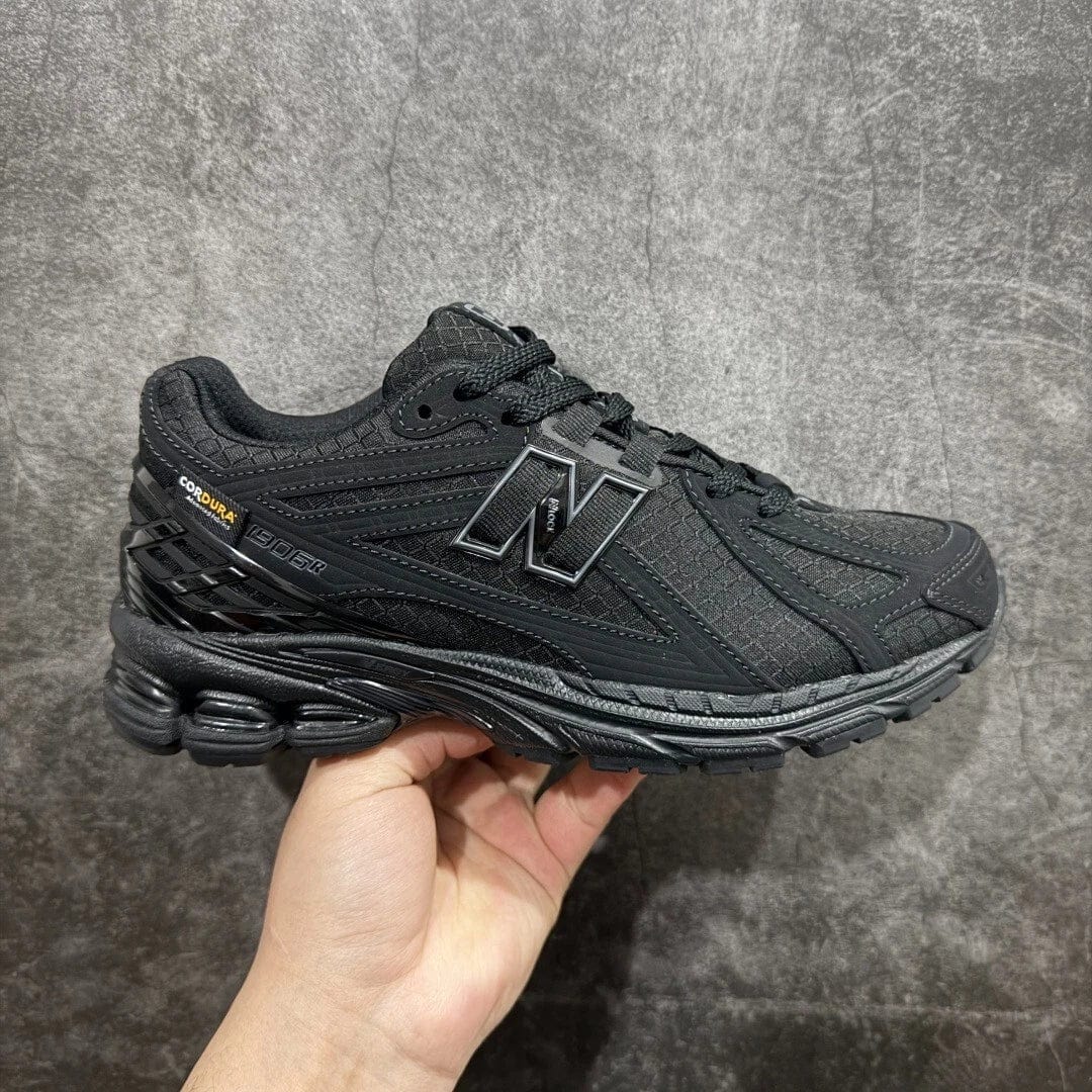s-l1600_12_8fcb9547-a666-476b-a0fc-f039a03c0640 | UAE SPORT STORE Black New Balance athletic shoe with a large N logo and rugged outsole, all-black with Cordura branding at the heel