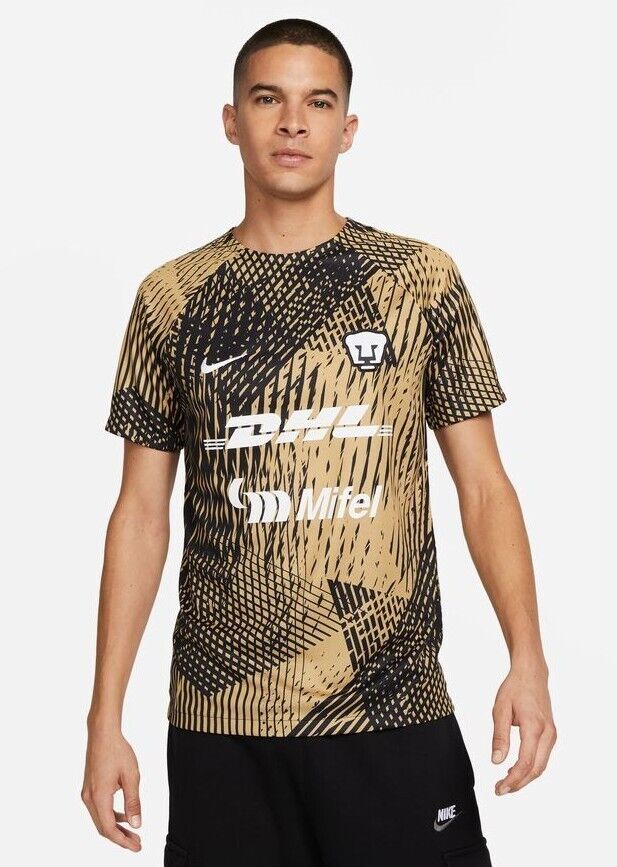 s-l1600_1_47d886a3-de97-4277-9d41-ebff81d85612 | UAE SPORT STORE Male model wearing a tan and black geometric-patterned soccer jersey with sponsor logos DHL and Mifel and a Nike swoosh on the chest.