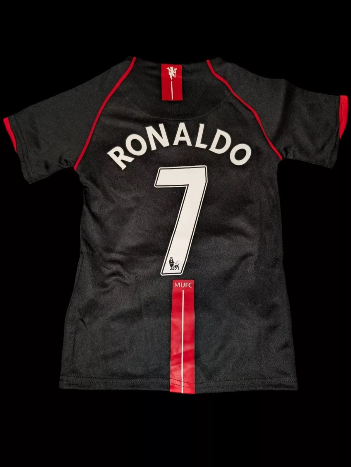 Back of black Manchester United jersey with Ronaldo 7 and red trim on shoulder and vertical stripe