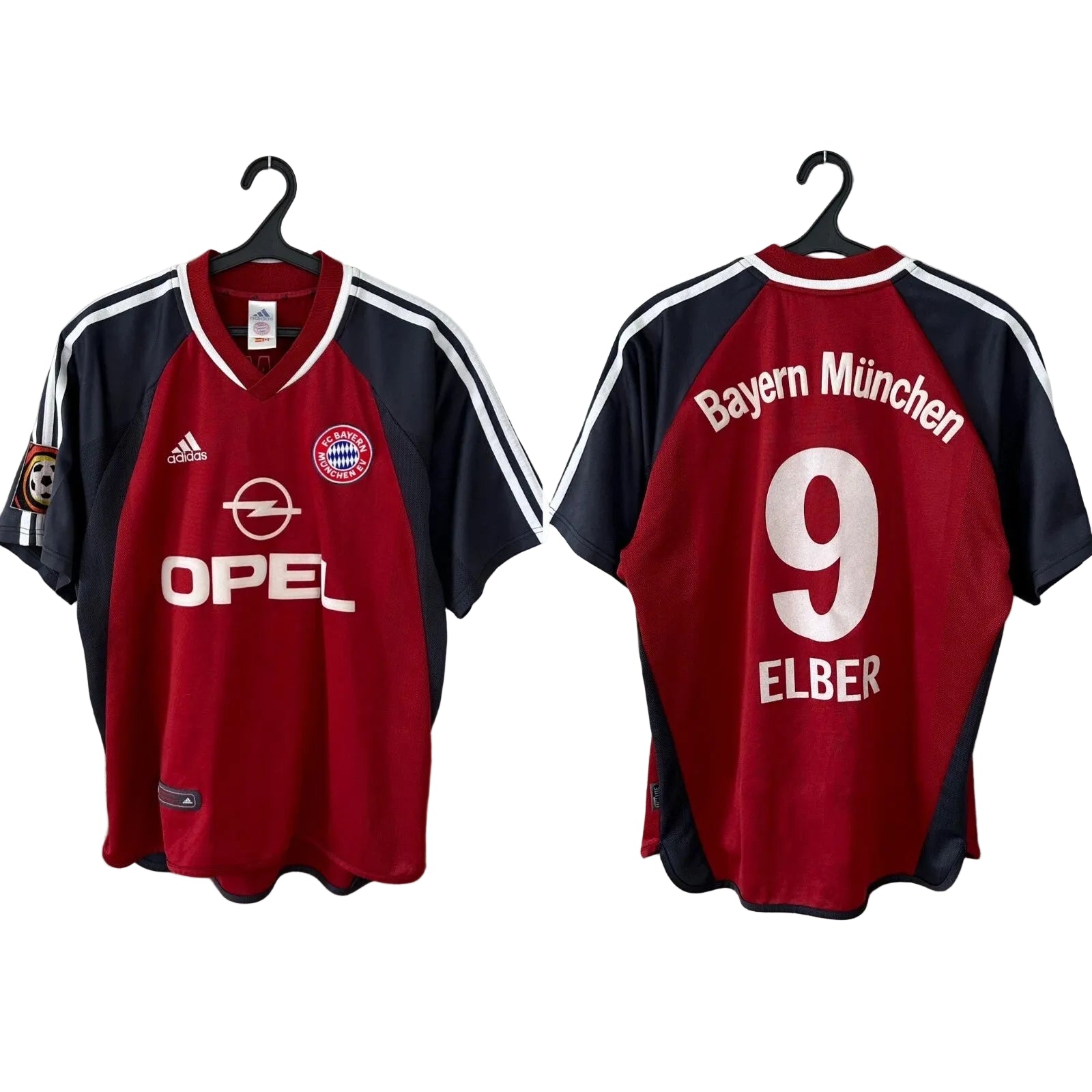 s-l1600_22a8ca44-97e3-43c0-a761-ef37a5a74464 Two Bayern Munich football jerseys on hangers shown front and back; red with navy sleeves, white stripes, crest, and Opel sponsor on the front.