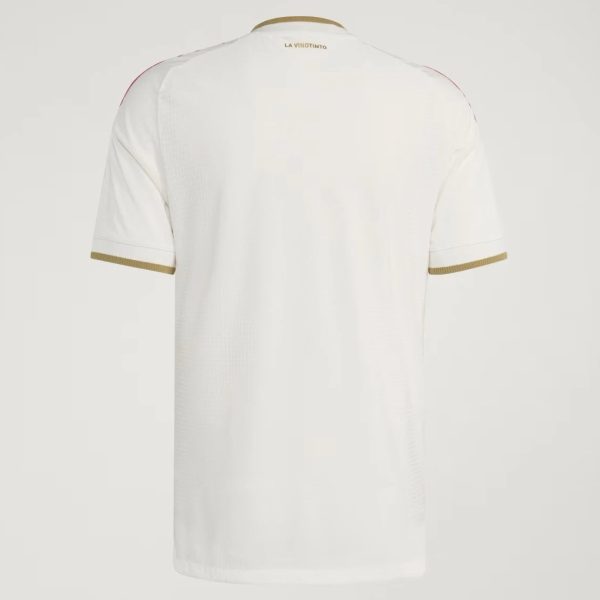 Back view of a white T-shirt with gold trim on the sleeve cuffs and neckline, LA VINOTINTO at the neck.