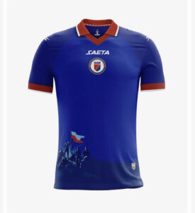 Blue Haiti national team soccer jersey with red collar and crest on chest.