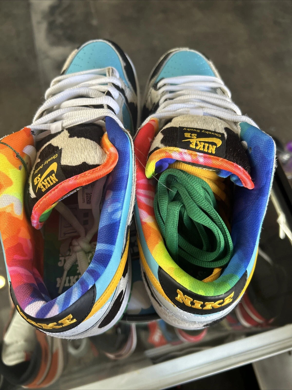 s-l1600_2_df2fdf13-65f5-4d62-9224-dba93bca1ba3 | UAE SPORT STORE Pair of rainbow-pattern high-top Nike sneakers viewed from above, white laces, light blue toe caps and multicolored interior.