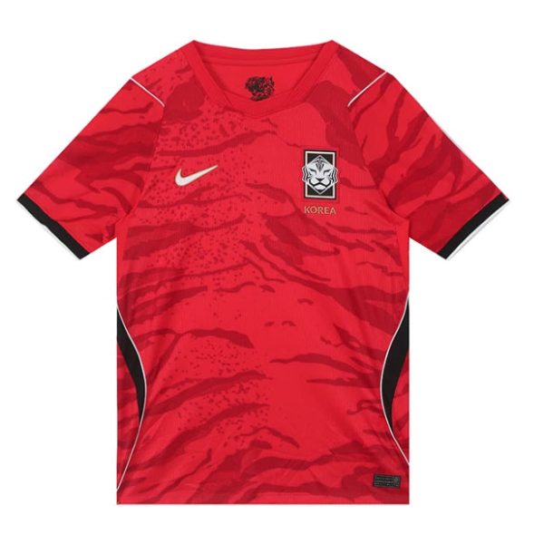 Red Korea national football team jersey with a white Nike swoosh and black-trimmed sleeves, featuring a tiger crest on the chest and side panels in black on white accents.