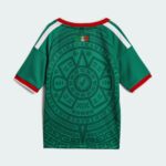 Back view of a green sports jersey with red collar, white shoulder stripes, and a circular geometric pattern across the back