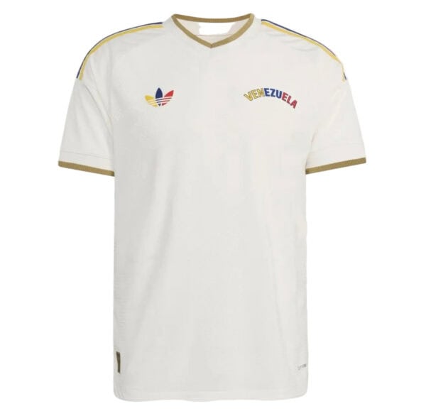 White short-sleeve soccer jersey with gold trim, Venezuela crest, and Adidas logo on the chest.