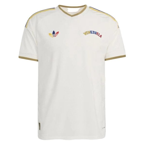White Venezuela national football (soccer) jersey with gold trim on collar and sleeves, Adidas logo and colorful crest/emblem on chest