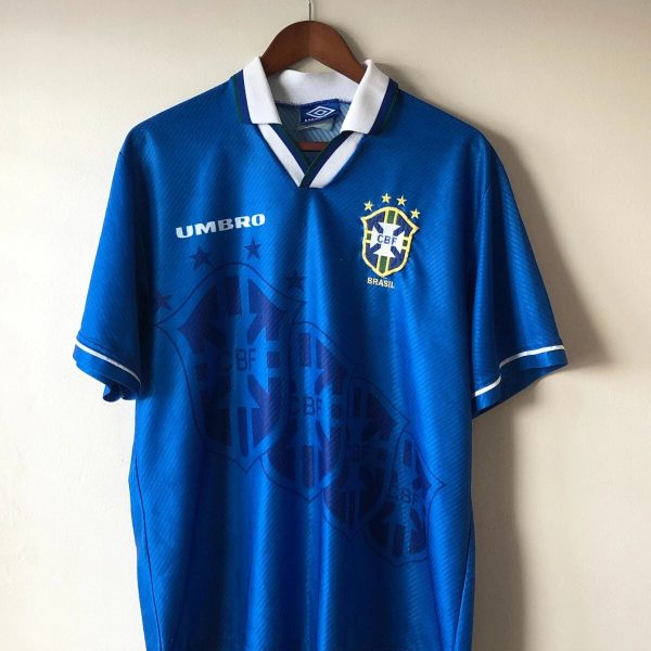 Blue Brazil national team soccer jersey on a wooden hanger, featuring the Umbro logo and CBF crest on the chest.