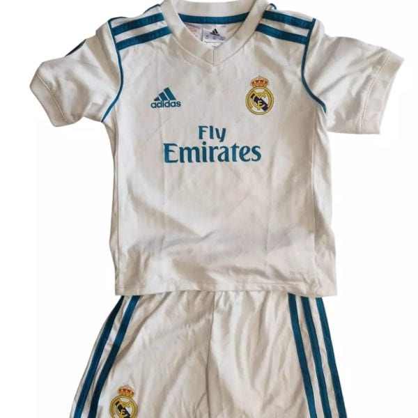 White Real Madrid soccer jersey and shorts set with blue trim, crest, and Fly Emirates sponsor.