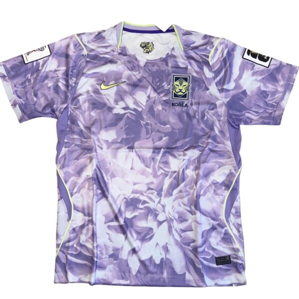 Purple camouflage sports jersey with lime trim, Korean emblem on chest and Nike swoosh on the front.