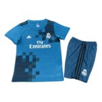 Blue Real Madrid football jersey with crest, sponsor Fly Emirates, and matching shorts with black stripes.