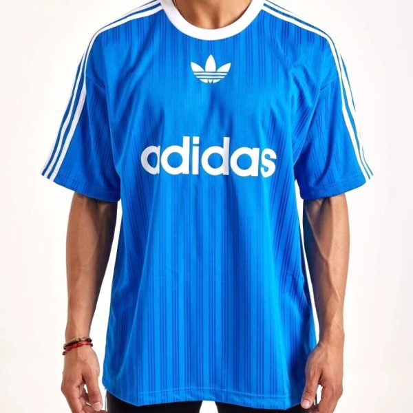 Blue Adidas sports jersey with white stripes on shoulders and large 'adidas' logo across the chest worn by a man.