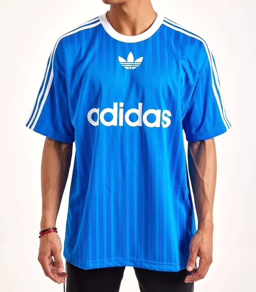 s-l1600_9_b7926eb2-a3a6-4f2c-a451-d0f7c5db8cd3 | UAE SPORT STORE Blue Adidas sports jersey with white stripes on shoulders and large 'adidas' logo across the chest worn by a man.