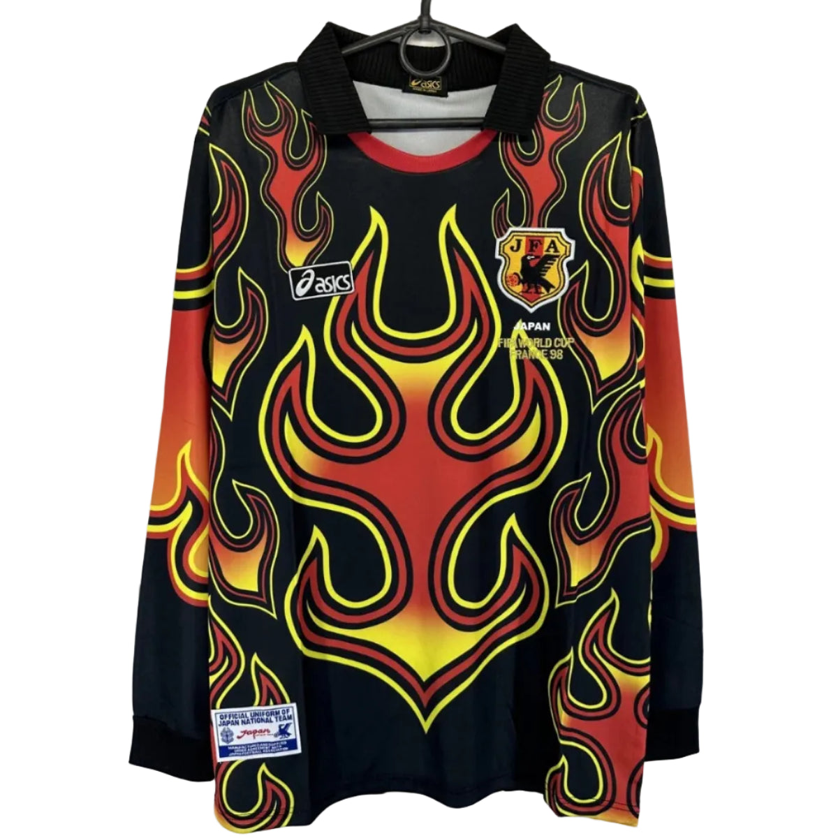 s-l1600_f8aeffe0-88bf-43f0-84d7-0d0bc26bb9eb | UAE SPORT STORE Black long-sleeve shirt with bright red-yellow flame pattern and black collar, sports jersey with JFA emblem and 'Japan World Cup 1998' text on chest