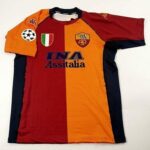 Roma football jersey split maroon and orange with sponsor INA Assitalia and club crest, plus patches (Italian flag and UEFA/league badge).