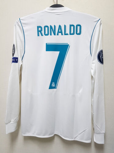 s-l500_12_5c7b2b00-10c8-4075-9d43-0e29816bf030 | UAE SPORT STORE White Real Madrid football jersey hung on a hanger; back shows blue 'RONALDO' and a large blue 7 with patches on the sleeves.