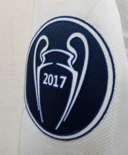 s-l500_14_a8f27002-b551-4da3-b5a1-36cae8a00775 | UAE SPORT STORE Oval navy patch with a white stylized trophy and the year 2017 on white fabric surface.