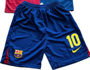 Blue FC Barcelona soccer shorts with club crest on the left leg, a bright yellow number 10 and a Nike swoosh on the right. Red panels run along the sides.