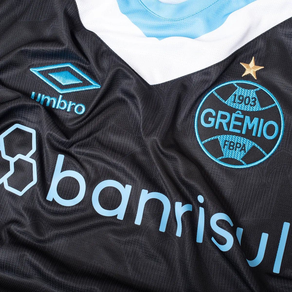 skal7WW56Kw4qVe | UAE SPORT STORE Black Grêmio football jersey with turquoise team crest, blue sponsor logos, and a star above the crest.