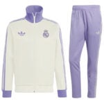 White and light purple Real Madrid track jacket with matching lavender pants; features Real Madrid crest and Adidas logo along purple stripes.